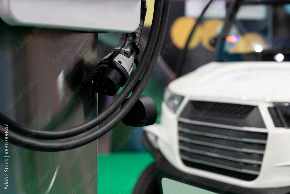 Close-up of a electric charging station on the background of electric car. Close-up of a electric charging station on the background of electric car.