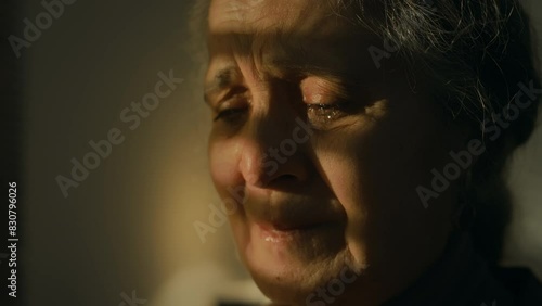 Closeup of crying Caucasian lady reading letter with bad news indoors, being full of tears feeling anguish and hopelessness