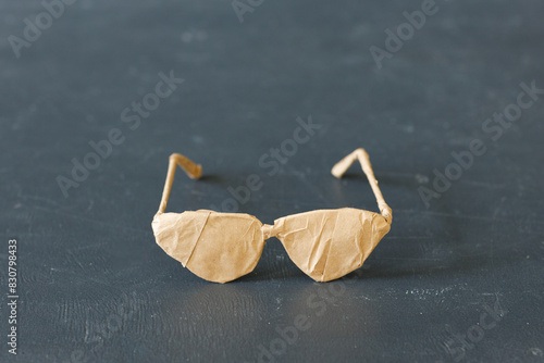 A brand new glasses wrapped in rustic beige craft paper. Black Friday shopping concept.