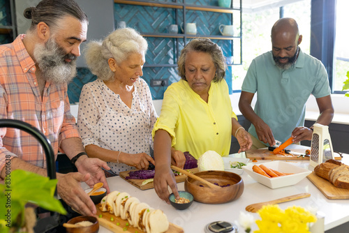 Diverse senior friends preparing food at home