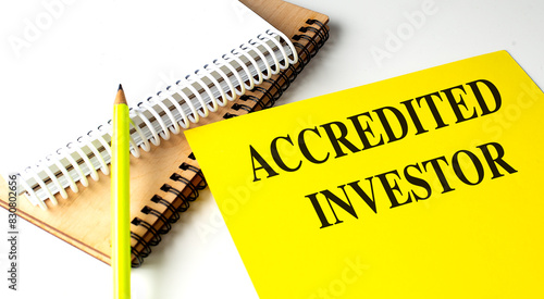 Obraz na płótnie ACCREDITED INVESTOR text on yellow paper with notebooks