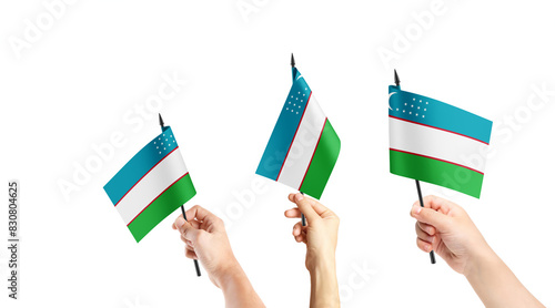 A group of people are holding small flags of Uzbekistan in their hands. photo