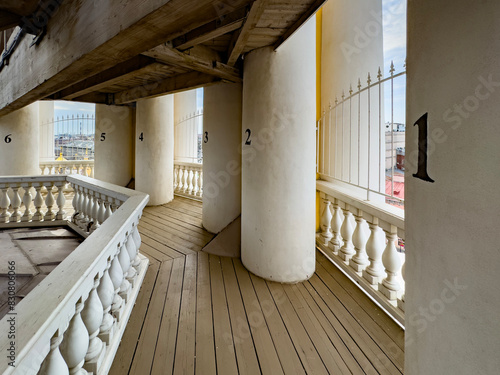 Interior balcony view with numbered columns in the Cathedral of the Vladimir Icon of the Mother of God in Saint Petersburg. Ideal for architectural, religious, and cultural projects.