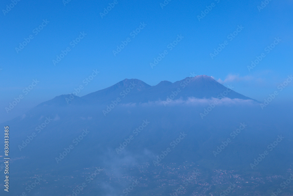 photo of mountains above clouds with beautiful blue sky