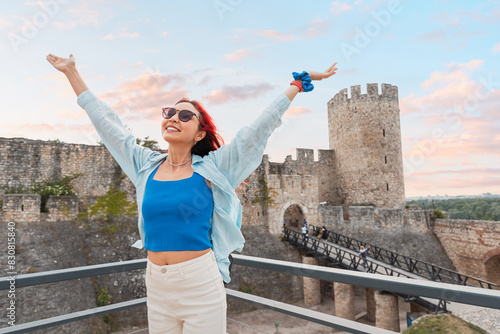 Obraz na płótnie Experience the vibrant energy of Belgrade with a portrait of a happy tourist exploring Kalemegdan fortress. w salonie