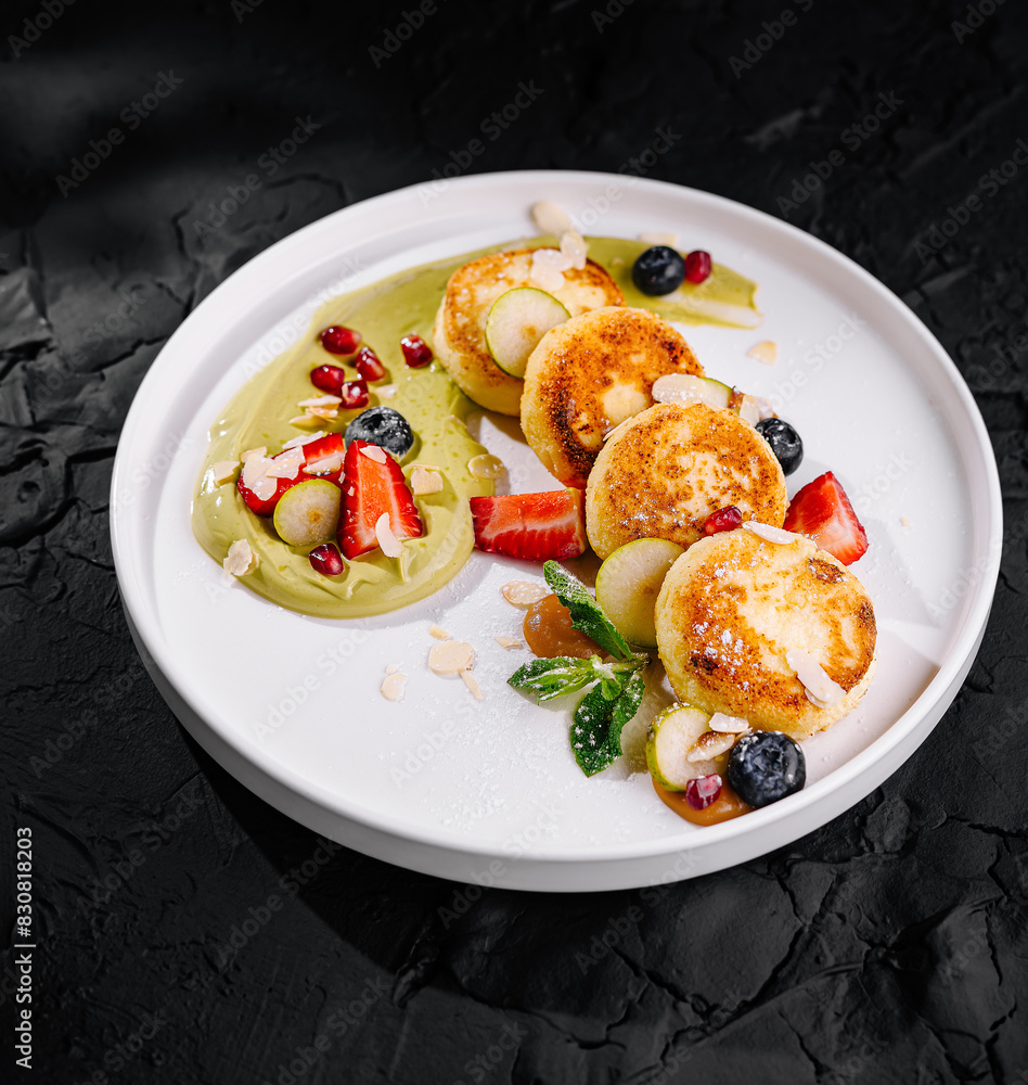 Gourmet cheese pancakes with fresh berries and sauce Gourmet cheese pancakes with fresh berries and sauce