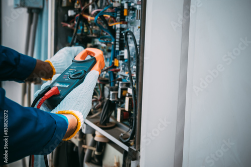 Wallpaper Mural Technician is checking air conditioner refrigerant system maintenance and check switch board control Torontodigital.ca