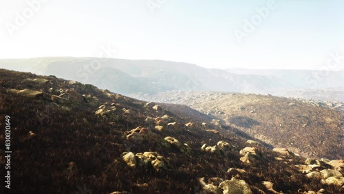 stunning shot of a foggy rocky landscape with partial grass coverage photo