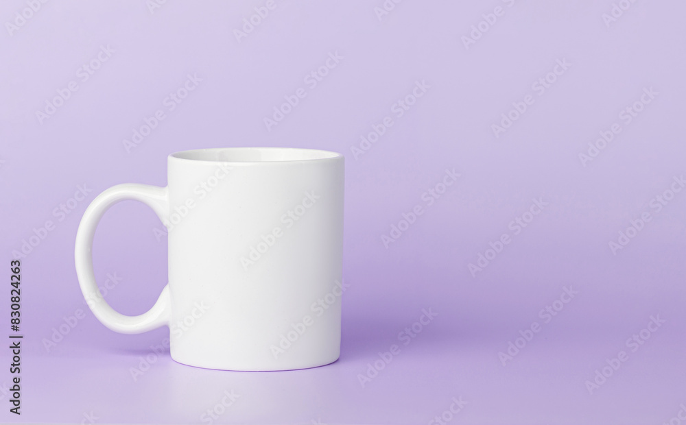 white cup for tea or coffee on a violet, purple background white cup for tea or coffee on a violet, purple background
