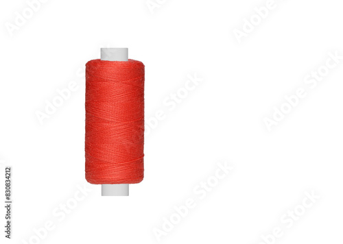 Red spool of sewing thread isolated on white background close up photo