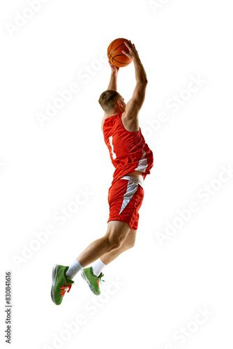 Basketball player, dressed in red uniform, performing perfect slam dunk against white studio background. Concept of professional sport, games, healthy lifestyle, tournament, action. Ad