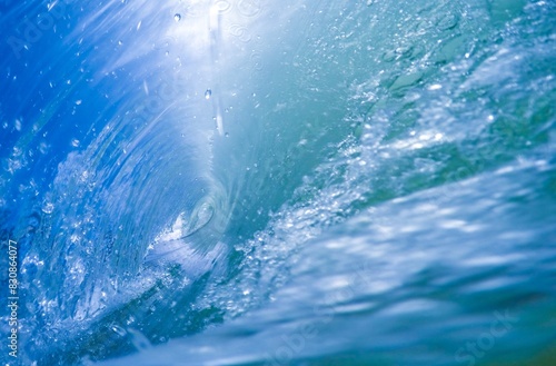 Inside a vibrant blue barrel wave photo