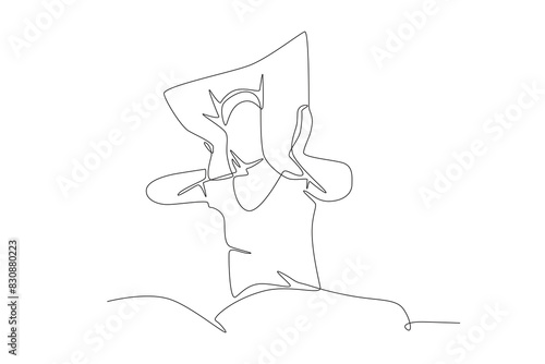 Woman having trouble sleeping covers her ears with a pillow. Struggling to sleep concept one-line drawing