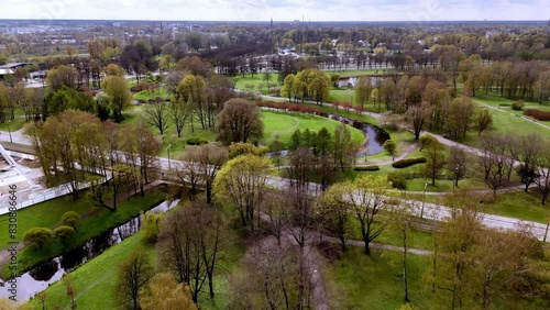 Riga, Latvia, Europe - A Serene and Welcoming Ambiance of Uzvaras Park (Victory Park) - Aerial Pullback Shot photo