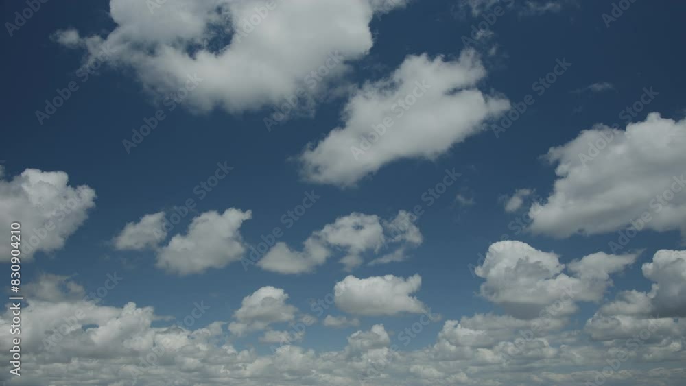 Beautiful cumulus clouds on a blue sky - time lapse video, slow movement of white clouds across the sky on a sunny spring day, nature weather blue sky, beautiful background for your projects. Beautiful cumulus clouds on a blue sky - time lapse video, slow movement of white clouds across the sky on a sunny spring day, nature weather blue sky, beautiful background for your projects.