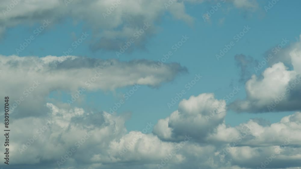 Beautiful cumulus clouds on a blue sky - time lapse video, slow movement of white clouds across the sky on a sunny spring day, nature weather blue sky, beautiful background for your projects. Beautiful cumulus clouds on a blue sky - time lapse video, slow movement of white clouds across the sky on a sunny spring day, nature weather blue sky, beautiful background for your projects.