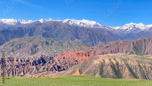Top view of the Konorchek canyons in Kyrgyzstan. Colorful mountains. Amazing mountain landscape. The peaks of the mountains are covered with snow photo