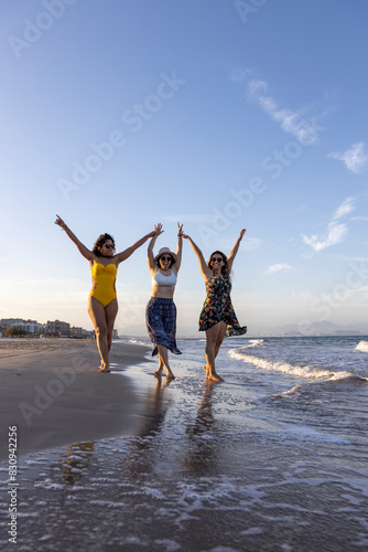 Group of girls hunging out on the beach