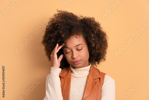 puzzled afro brazilian woman with hands over the face in beige background. frustration, unhappy, problem concept.