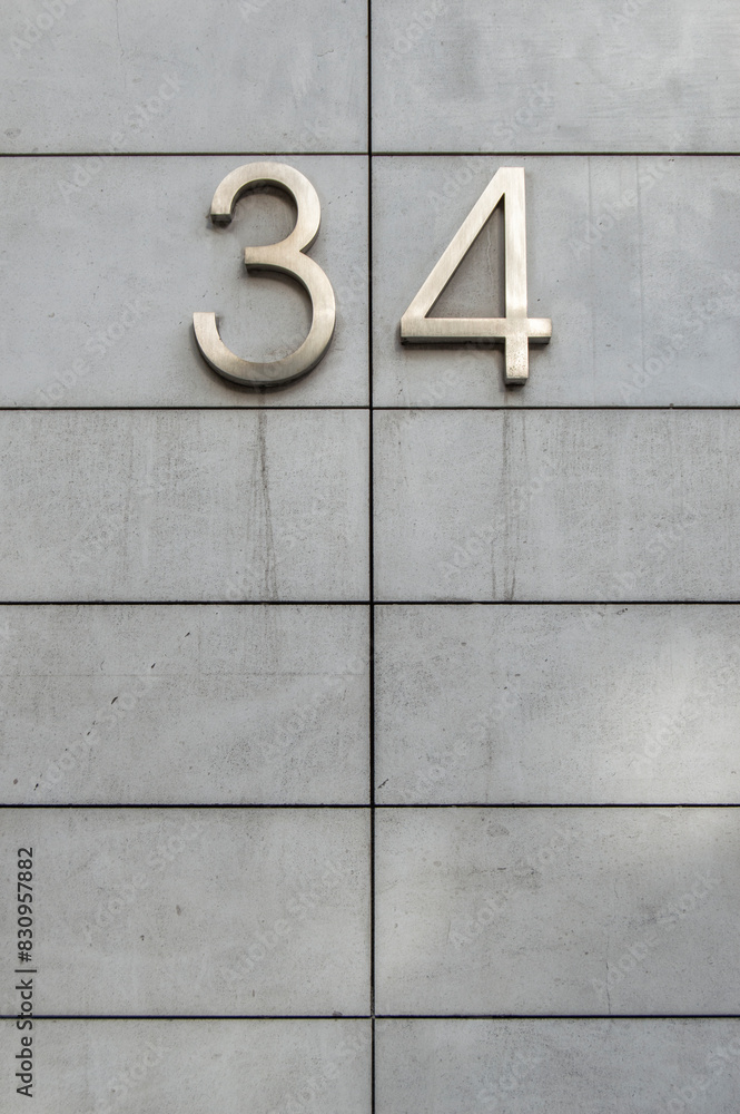 metal number thirty-four in a facade divided into rectangles in horizontally metal number thirty-four in a facade divided into rectangles in horizontally
