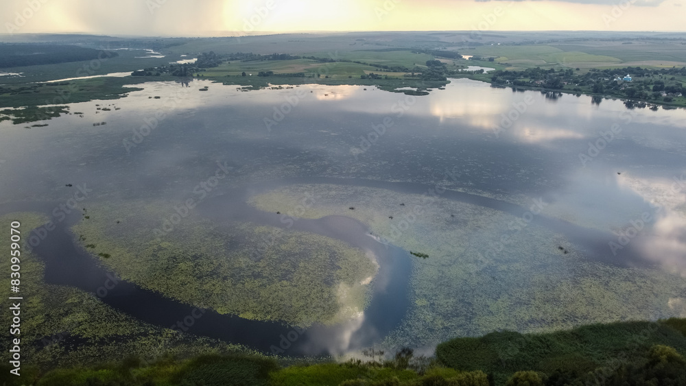 aerial view of Khrinnyky water reservoir, lake or swamp, with field and forest