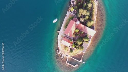 Aerial drone view of small island in the sea with church Lady of the Tickle church or Gospa od Skrpjela in Perast, Montenegro. photo