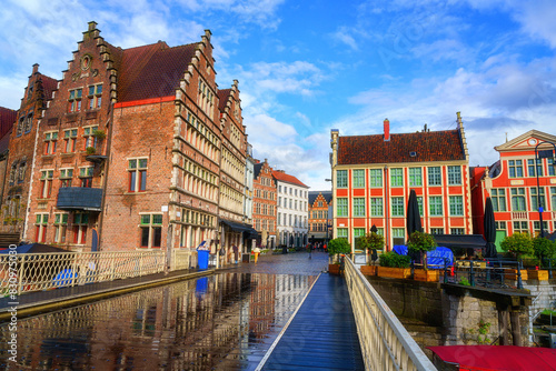 Scenic view of colorful buildings from Grasbrug bridge, historical center of Ghent (Gent), Belgium. Beautiful cityscape with medieval architecture and monumental landmarks, outdoor travel background