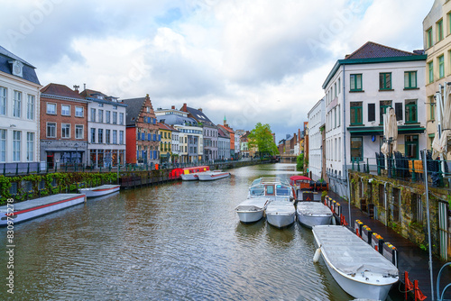 Scenic view of the historical city center of Ghent (Gent), Belgium. Beautiful cityscape with medieval architecture, monumental landmarks and Lys river with tourist boats, outdoor travel background