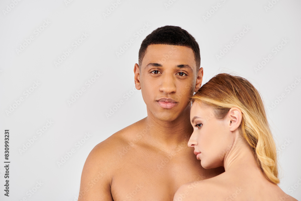 Attractive man and woman elegantly pose in front of white backdrop. Attractive man and woman elegantly pose in front of white backdrop.