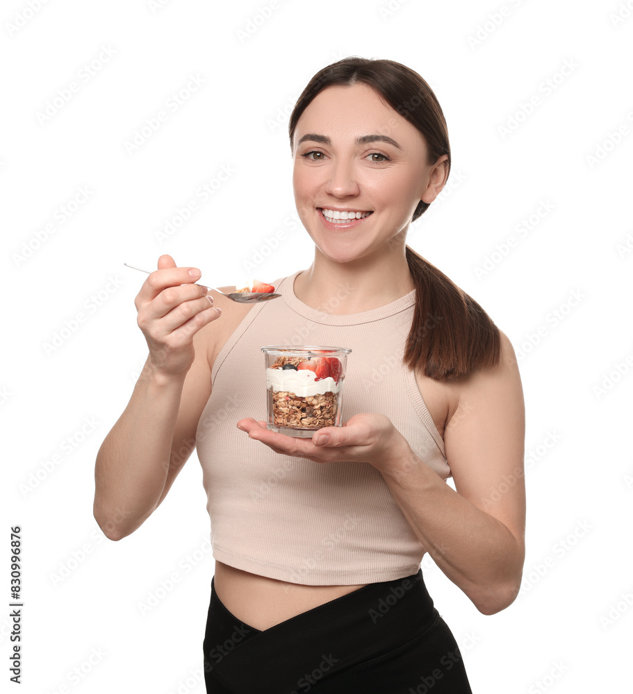 Happy woman eating tasty granola with fresh berries and yogurt on white background Happy woman eating tasty granola with fresh berries and yogurt on white background