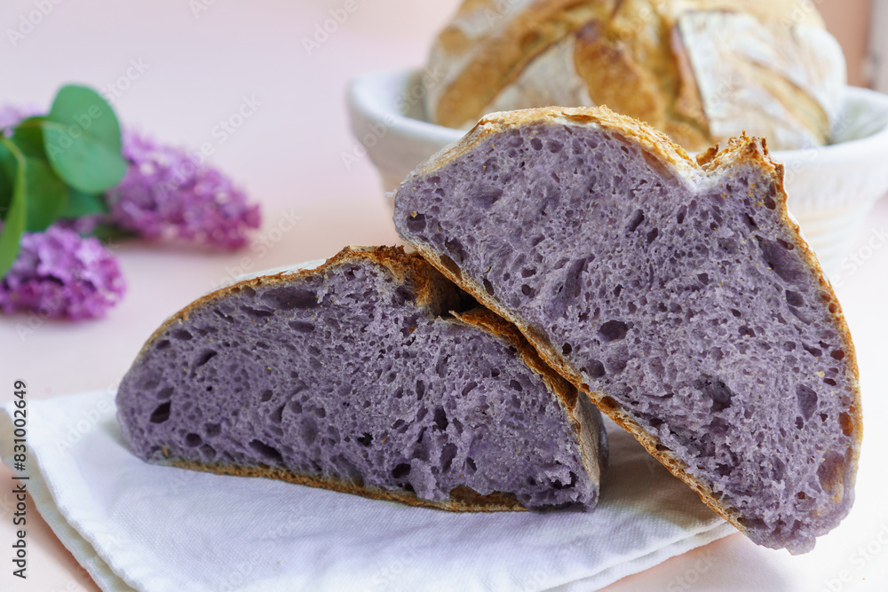 Homemade Artisan Purple Bread Sourdough Made from Purple Sweet Potato. with natural color. Purple tartine cut into slices. Homemade Artisan Purple Bread Sourdough Made from Purple Sweet Potato. with natural color. Purple tartine cut into slices.