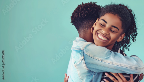 A mentor sharing a heartfelt hug with their mentee after a successful achievement, celebrating the moment together in a supportive environment, with copy space photo