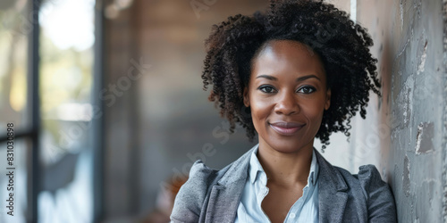 an African American businesswoman posing confidently for a portrait, radiating happiness and alignment with her firm's vision of excellence and success.