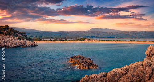 Fototapeta Naklejka Na Ścianę i Meble -  Sunset on rocky coast of Voidokilia Beach. Impressive summer seascpae of Ionian sea, Pilos town location, Peloponnese peninsula, Greece, Europe. Vacation concept background.