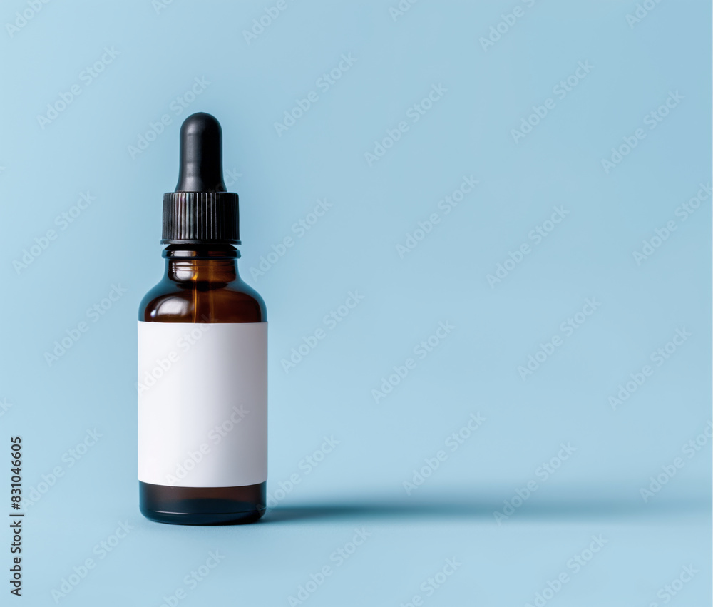 Dropper Bottle Mockup Blue Background: Brown Dropper Bottle with Blank White Label for Minimalistic Product Packaging - Ideal for Cosmetics, Essential Oils, or Skincare Products - Copy Space