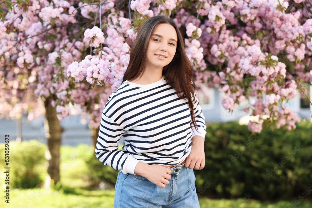 Beautiful woman near blossoming tree on spring day Beautiful woman near blossoming tree on spring day