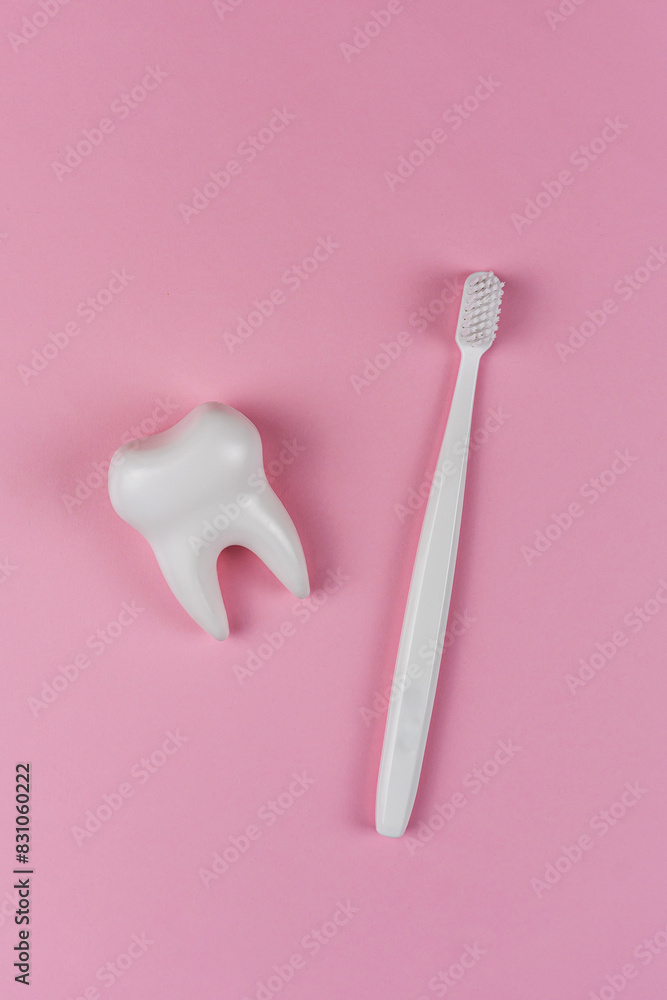 Healthy white tooth and toothbrush on a pink background. The concept of dentistry, health, dental clinic, health care, oral care. Oral hygiene, professional teeth cleaning, copyspace for text Healthy white tooth and toothbrush on a pink background. The concept of dentistry, health, dental clinic, health care, oral care. Oral hygiene, professional teeth cleaning, copyspace for text