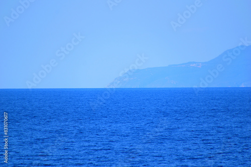 seascape with a cloudy mountain - mount Athos, Greece, aegean sea