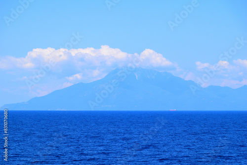 seascape with a cloudy mountain - mount Athos, Greece, aegean sea