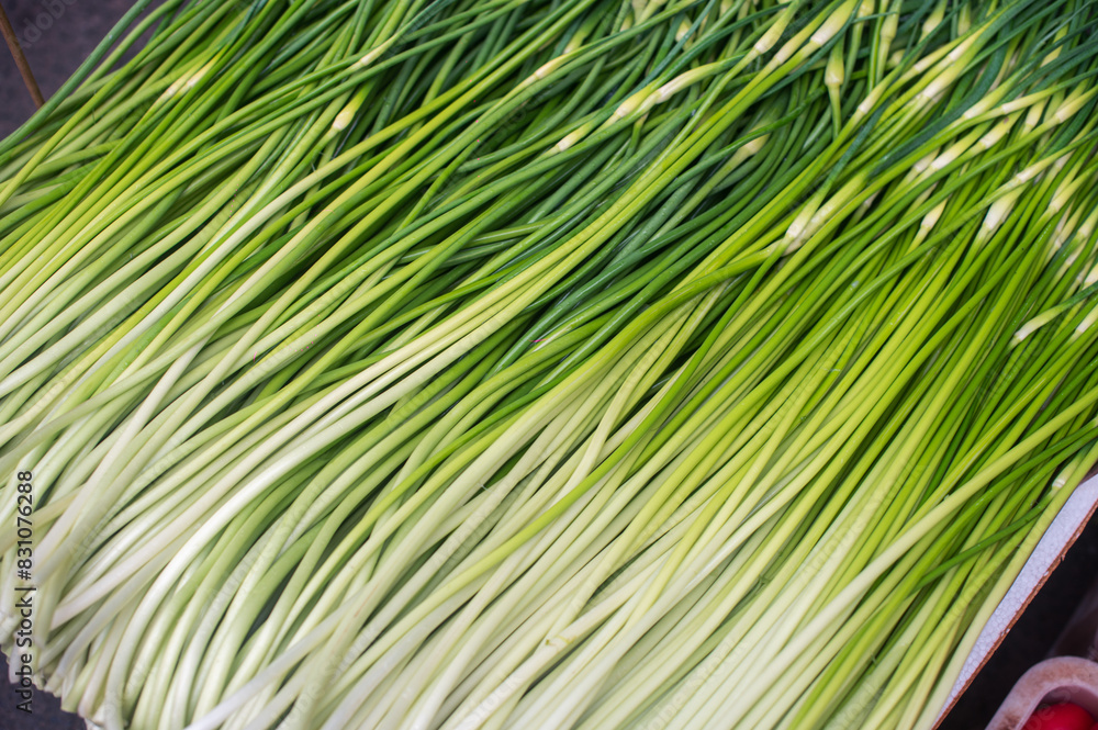 a tray full of green onions on top of a table