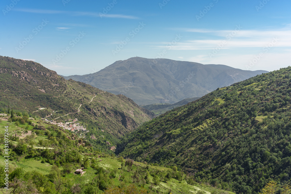 Mountain scenery of the Alpujarra Granadina with a small white village Mountain scenery of the Alpujarra Granadina with a small white village