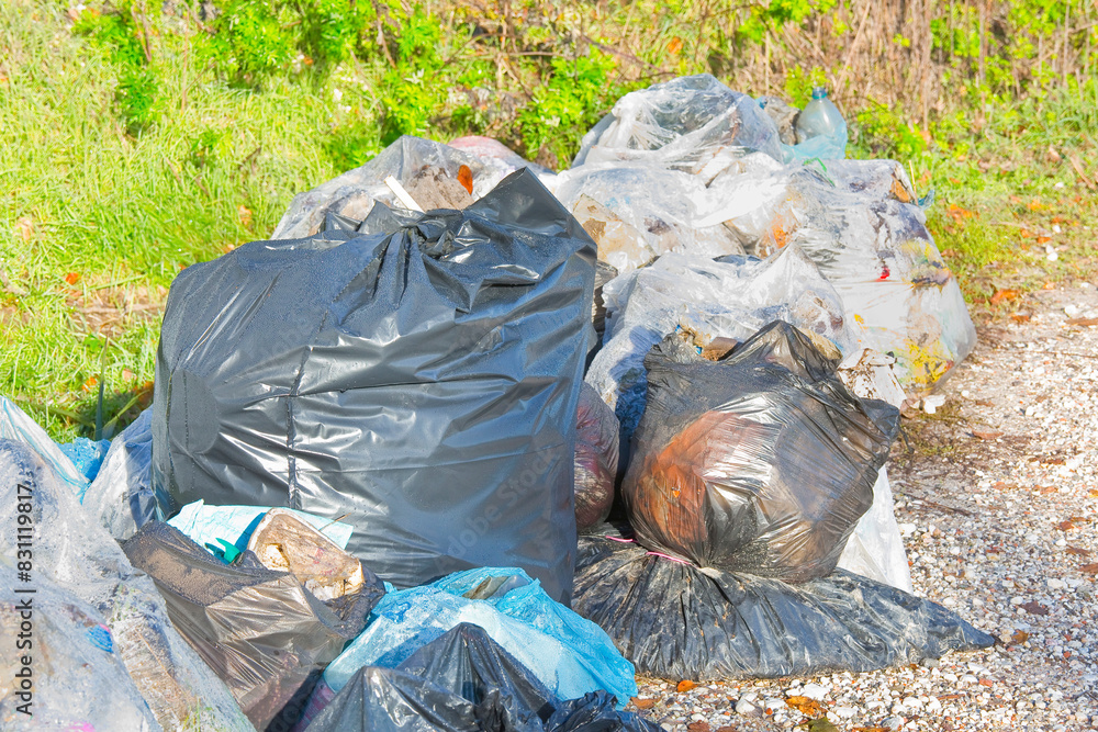 Illegal dumping with plastic bags abandoned in nature Illegal dumping with plastic bags abandoned in nature
