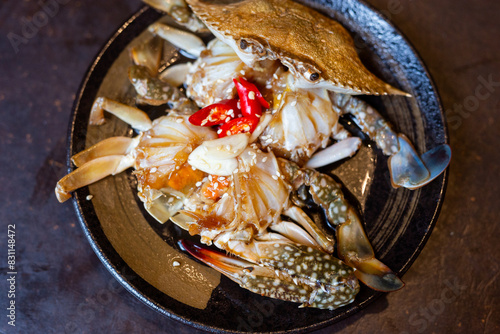 pickled fresh crab marinated in fish sauce on plate in a restaurant