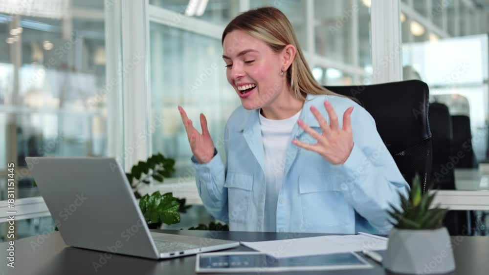 Delighted woman exclaiming with joy upon seeing positive email on display of wireless laptop in office. Cheerful caucasian lady gesturing enthusiastically and swiftly typing response on keyboard. Delighted woman exclaiming with joy upon seeing positive email on display of wireless laptop in office. Cheerful caucasian lady gesturing enthusiastically and swiftly typing response on keyboard.
