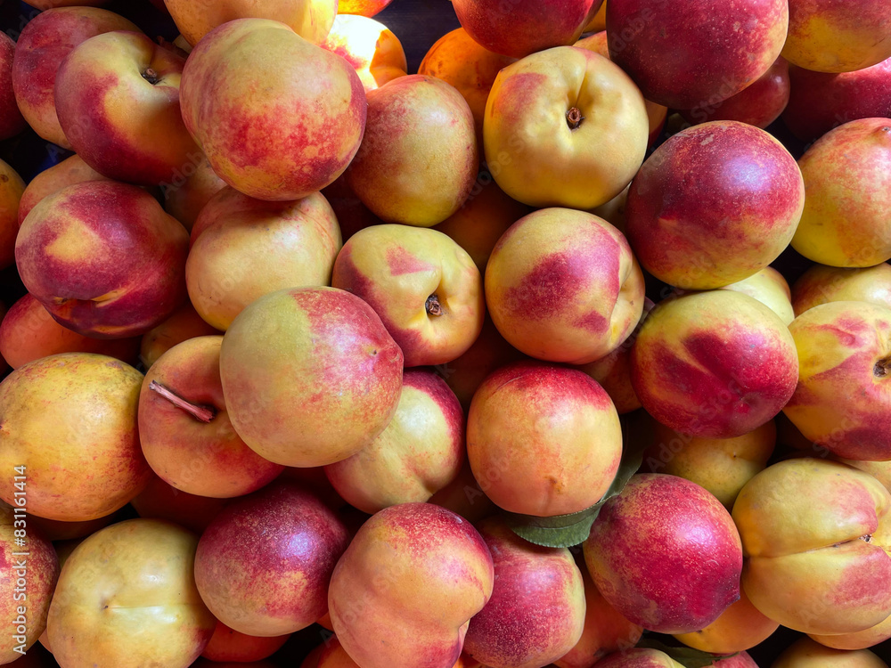 Pile of ripe freshly picked organic peaches. Pile of peach harvest. Healthy vegan raw snack. Clean eating concept. Cropped shot, background, top view. Pile of ripe freshly picked organic peaches. Pile of peach harvest. Healthy vegan raw snack. Clean eating concept. Cropped shot, background, top view.