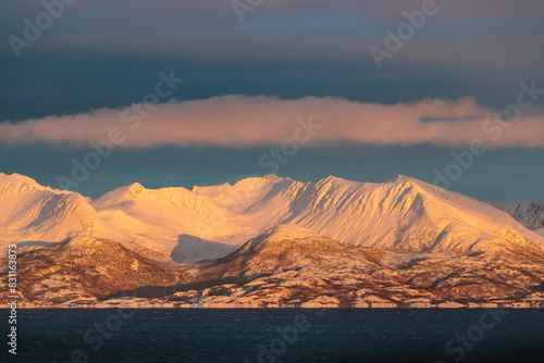 Obraz na płótnie The magical light of the ending polar day on the snowy hills of Lofoten, Norway w salonie