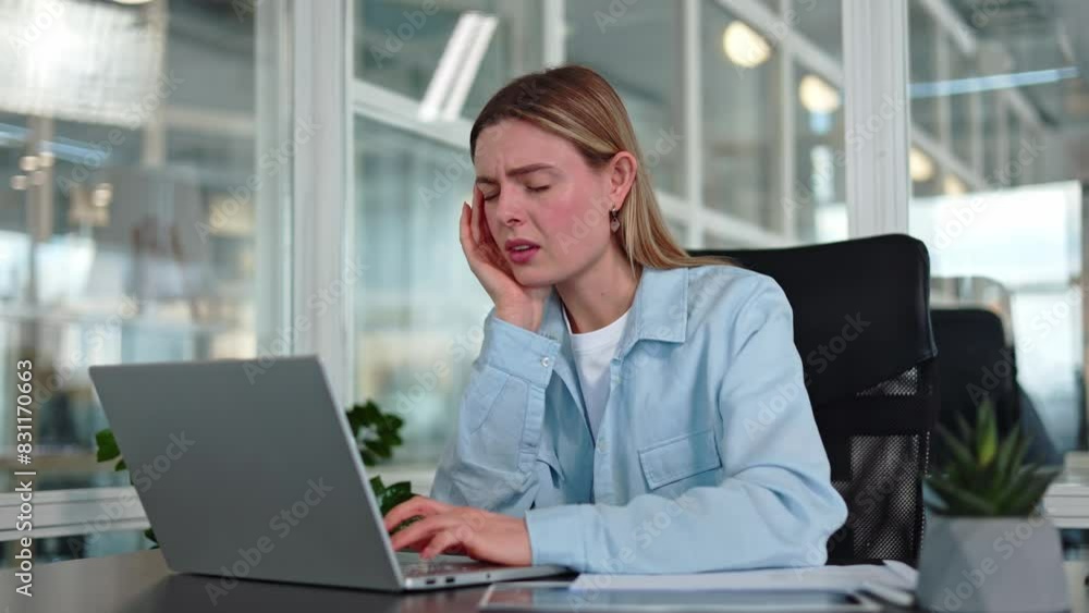 Front view of sad caucasian manager woman with painful facial expression touching mouth at workplace. Frustrated blond female dressed in casual wear suffering from toothache during work on laptop. Front view of sad caucasian manager woman with painful facial expression touching mouth at workplace. Frustrated blond female dressed in casual wear suffering from toothache during work on laptop.