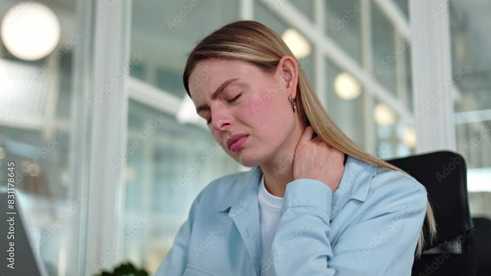 Distressed caucasian woman struggling to alleviate throbbing pain in neck while diligently working away at personal laptop. Worried female massaging body in office environment. Concept of healthcare. Distressed caucasian woman struggling to alleviate throbbing pain in neck while diligently working away at personal laptop. Worried female massaging body in office environment. Concept of healthcare.