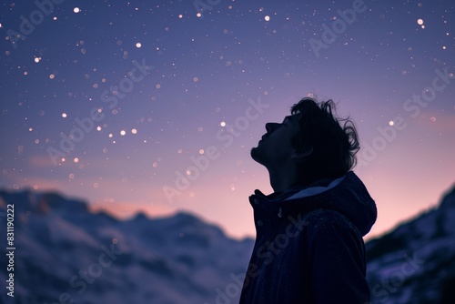 A person is looking up at a starry night sky, dreaming