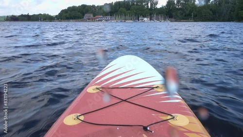 SUP Paddleboard ridign through waves photo